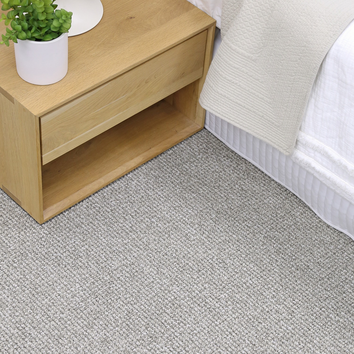 Woodchester organic loop carpet beside a timber bedside table